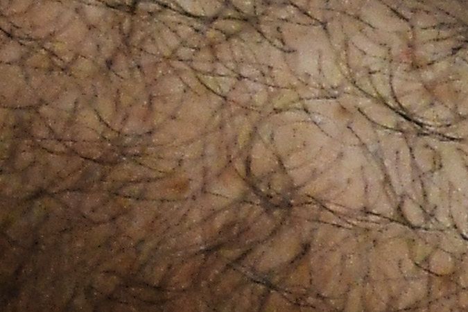 Detail of the hands of former Salvadoran President (2004-2009) Elias Antonio Saca with handcuffs, taken as he waits, along with six of his collaborators, for the judge to arrive in court in San Salvador on May 16, 2018, to face charges of embezzlement and laundering for allegedly diverting 298 million dollars. - Saca was arrested in October 2016 with his former private secretary and former communications secretary, among others, suspected of pocketing $246 million in public funds during his 2004-2009 mandate. They have been charged with embezzlement, criminal association and money laundering. (Photo by Marvin RECINOS / AFP) (Photo credit should read MARVIN RECINOS/AFP via Getty Images)