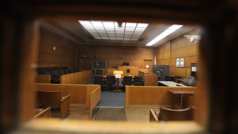 A view through the door window of a courtroom closed due to budget cuts and layoffs, at the Stanley Mosk Courthouse in downtown Los Angeles March 16, 2009. Beset by an unprecedented budget crisis, the LA Superior Court, the largest trial court system in the US, today laid of 329 employees and announced the closure of 17 courtrooms, with more of both expected in the future. AFP PHOTO / Robyn BECK (Photo credit should read ROBYN BECK/AFP via Getty Images)