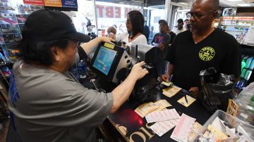 Customers buy Mega Millions tickets hours before the draw of the USD 1 billion jackpot, at the Bluebird Liquor store in Torrance, California on October 19, 2018. (Photo by Mark RALSTON / AFP) (Photo credit should read MARK RALSTON/AFP via Getty Images)