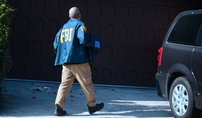 An FBI agent carries a case from the home of Los Angeles Councilman Jose Huizar in Los Angeles on November 7, 2018. - The FBI served sealed warrants at the home, field and City Hall offices of Huizar. FBI officials declined on what the searches entailed. (Photo by Frederic J. BROWN / AFP) (Photo credit should read FREDERIC J. BROWN/AFP via Getty Images)