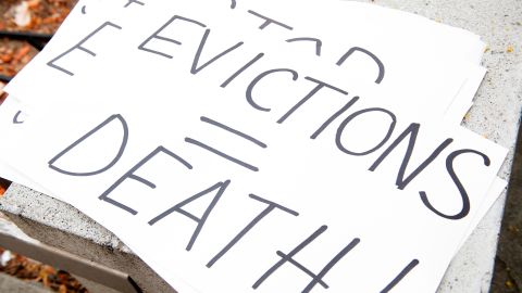 Signs are seen during a protest to cancel rent and avoid evictions in front of the court house amid Coronavirus pandemic on August 21, 2020, in Los Angeles, California. (Photo by VALERIE MACON / AFP) (Photo by VALERIE MACON/AFP via Getty Images)