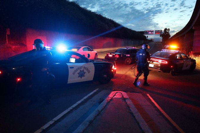 OAKLAND, CALIFORNIA - MAY 29: California Highway Patrol officers block a freeway entrance during a protest sparked by the death of George Floyd while in police custody on May 29, 2020 in Oakland, California. Earlier today, former Minneapolis police officer Derek Chauvin was taken into custody for Floyd's death. Chauvin has been accused of kneeling on Floyd's neck as he pleaded with him about not being able to breathe. Floyd was pronounced dead a short while later. Chauvin and 3 other officers, who were involved in the arrest, were fired from the police department after a video of the arrest was circulated. (Photo by Justin Sullivan/Getty Images)
