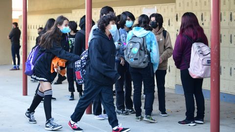 Students return to campus at Olive Vista Middle School on the first day back following the winter break amid a dramatic surge in Covid-19 cases across Los Angeles County on January 11, 2022 in Sylmar, California. - Tens of thousands of Los Angeles Unified School District students returned to classes today after the winter break with district requirements for all staff and students to be tested for Covid-19 from the thousands of take-home test kits provided to students with a negative result allowing entry. (Photo by Frederic J. BROWN / AFP) (Photo by FREDERIC J. BROWN/AFP via Getty Images)