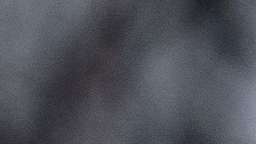 Police tape is seen in front of a police vehicle as Manuel Oliver displays a banner calling on government officials to prioritize gun violence prevention from a construction crane near the White House in Washington, DC, on February 14, 2022. Oliver's son Joaquin Oliver was killed in the Parkland School shooting four years ago today. (Photo by Stefani Reynolds / AFP) (Photo by STEFANI REYNOLDS/AFP via Getty Images)