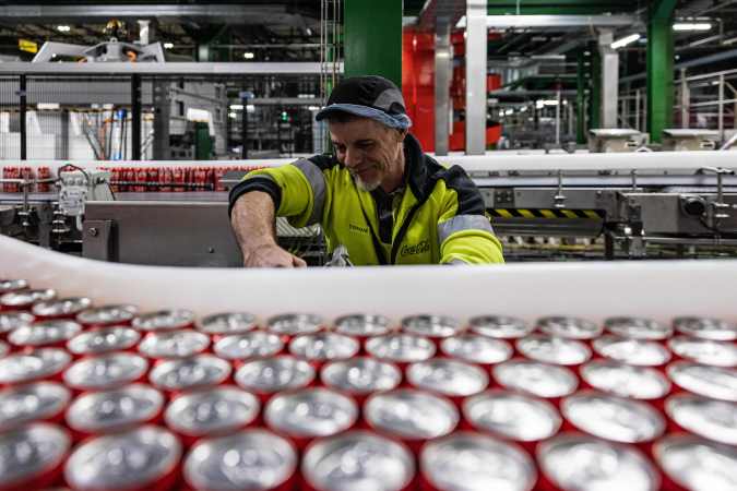 An operator works at the Coca Cola factory in Bierne, northern France on January 26, 2023. - The CCEP group, bottler of a dozen brands of carbonated and non-carbonated beverages on the site (Coca Cola, Fanta, Sprite, Fruzetea, Minute Maid, PowerAde, Tropico, Monster ...) says it wants to reduce its CO2 emissions by 30% by 2030 to achieve carbon neutrality in 2040. (Photo by Sameer Al-DOUMY / AFP) (Photo by SAMEER AL-DOUMY/AFP via Getty Images)