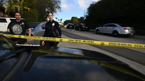 Police officers secure the crime scene as they await investigators after an early morning shooting that left three people dead and four wounded in the Beverly Crest neighborhood of Los Angeles, just north of Beverly Hills, on January 28, 2023. - Three people were shot dead January 28 and four others injured at a luxury home near Beverly Hills, at what US police described as a gathering at a short-term rental property. (Photo by Robyn BECK / AFP) (Photo by ROBYN BECK/ AFP/AFP via Getty Images)