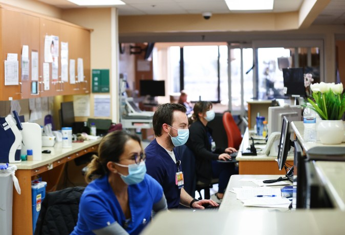 APPLE VALLEY, CALIFORNIA - MARCH 11: (EDITORIAL USE ONLY) Jesse Cabe (C) and other registered nurses work in the ICU at Providence St. Mary Medical Center on March 11, 2022 in Apple Valley, California. The hospital was treating 125 confirmed COVID-19 patients at the peak of the Omicron surge but has seen a sharp decline and is currently caring for 13 confirmed coronavirus patients. Today marks the two year anniversary of the World Health Organization’s official declaration of the COVID-19 pandemic. (Photo by Mario Tama/Getty Images)