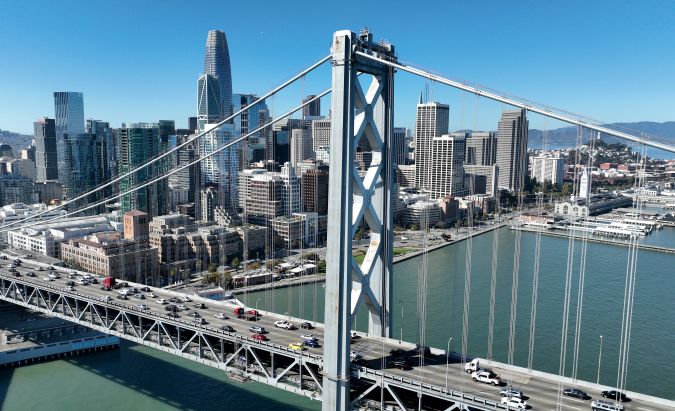 SAN FRANCISCO, CALIFORNIA - OCTOBER 27: In an aerial view, cars drive by the San Francisco skyline as they cross the San Francisco-Oakland Bay Bridge on October 27, 2022 in San Francisco, California. According to a report by commercial real estate firm CBRE, the city of San Francisco has a record 27.1 million square feet of office space available as the city struggles to rebound from the Covid-19 pandemic. The US Census Bureau reports an estimated 35% of employees in San Francisco and San Jose continue to work from home. (Photo by Justin Sullivan/Getty Images)