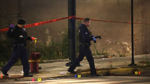 CHICAGO, ILLINOIS - OCTOBER 31: Police investigate the scene where as many as 14 people were reported to have been shot on October 31, 2022 in Chicago, Illinois. Three juveniles were among those reported to have been wounded in the drive-by shooting, according to published reports. (Photo by Scott Olson/Getty Images)