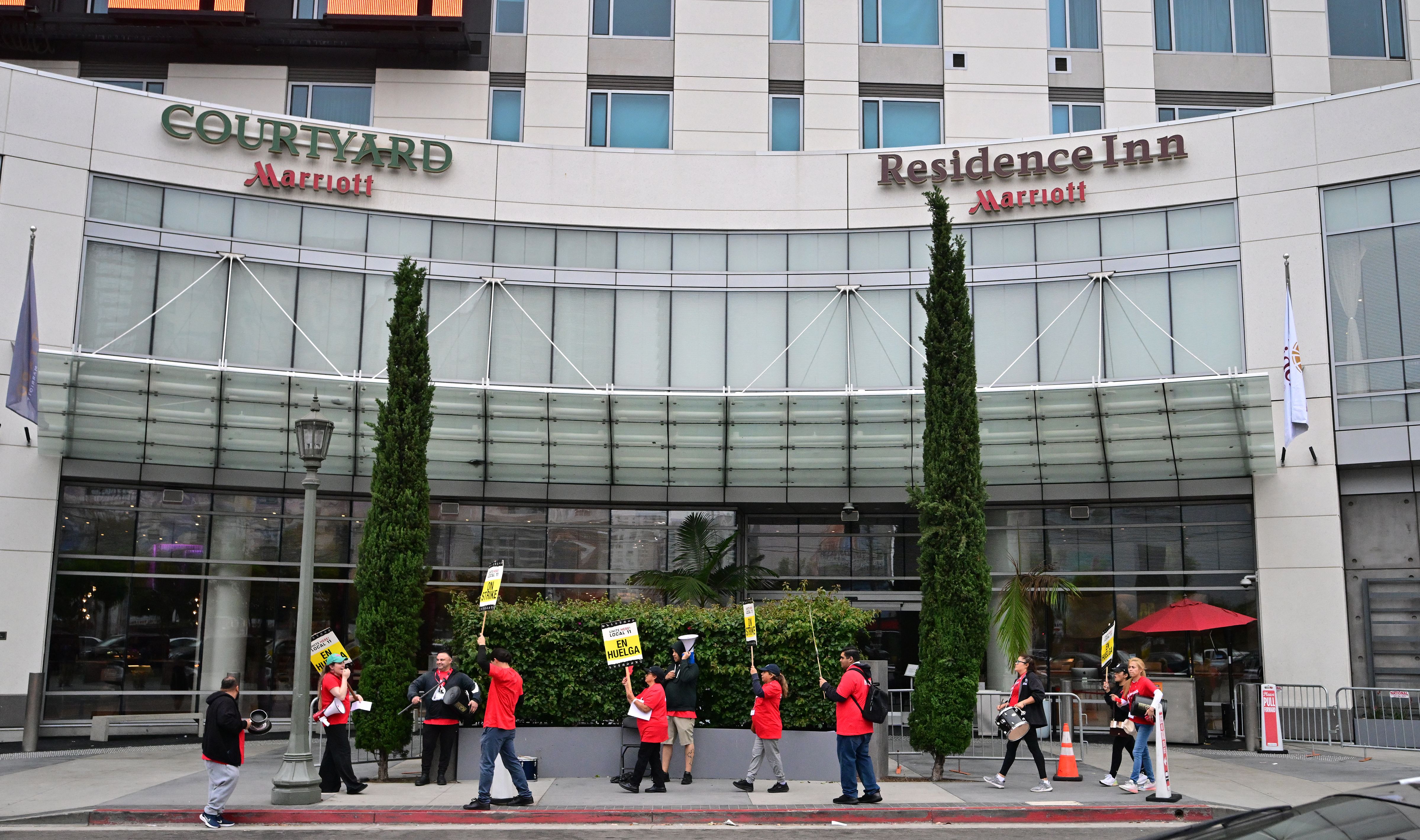 Hotel workers hold placards during the second day on their strike for a better wage in front of the Courtyard Marriot Hotel on July 3, 2023 in Los Angeles, California. Contracts between UNITE HERE Local 11 and 61 hotels expired at midnight on Friday, June 30. (Photo by Frederic J. BROWN / AFP) (Photo by FREDERIC J. BROWN/AFP via Getty Images)