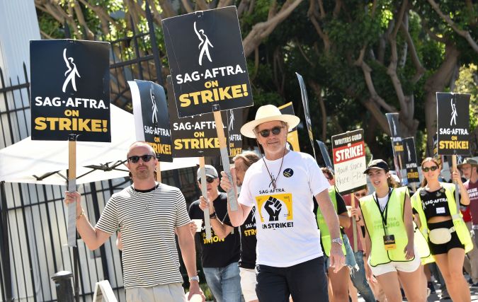 US actors Bryan Cranston and Aaron Paul join the Screen Actors Guild (SAG-AFTRA) picket line in front of Sony Pictures Entertainment Studios in Culver City, California, on August 29, 2023. The SAG-AFTRA walkout, and another strike by film and TV writers that began in May over pay and the threat of artificial intelligence, have brought US film and television production to a halt. (Photo by Chris Delmas / AFP) (Photo by CHRIS DELMAS/AFP via Getty Images)