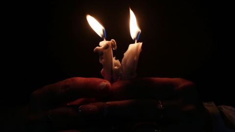 TOPSHOT - Iraqis attend a candle vigil for the victims of the wedding hall fire, at the church of Mart Shmoni, in Arbil, the capital of the autonomous Kurdish region of northern Iraq, on September 30, 2023. At least 100 people were killed when a fire ripped through a crowded Iraqi wedding hall, officials said, pointing to indoor fireworks as the likely cause for the blaze that sparked a panicked stampede for the exits. (Photo by Safin HAMID / AFP) (Photo by SAFIN HAMID/AFP via Getty Images)