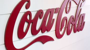 This photo taken on June 7, 2013, in Clamart, near Paris, shows the Coca-Cola logo on the side of an assembly line at a Coca Cola bottling plant. AFP PHOTO / LIONEL BONAVENTURE (Photo by LIONEL BONAVENTURE / AFP) (Photo by LIONEL BONAVENTURE/AFP via Getty Images)