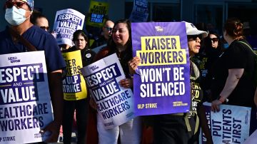 Empleados de Kaiser Permanente acompañados por miembros del sindicato hacen huelga en Los Ángeles.