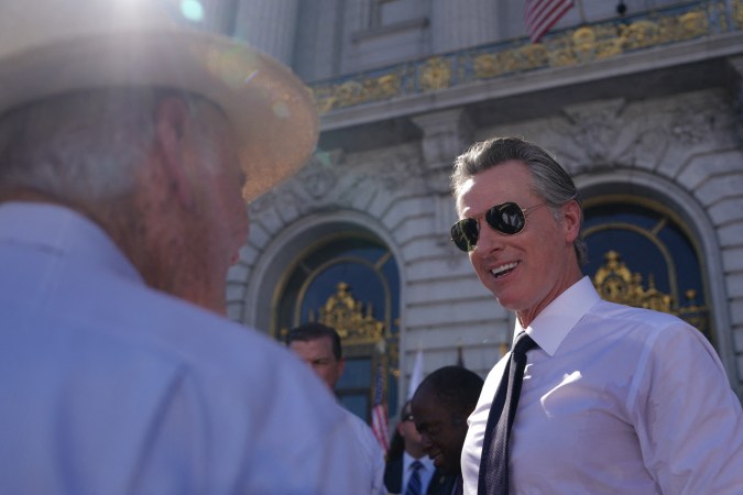 California Governor Gavin Newsom greets fellow attendees at the conclusion of the funeral service for US Senator Dianne Feinstein at San Francisco City Hall on October 5, 2023 in San Francisco, California. Feinstein, a titan of US political history who notched a string of legislative achievements during a trailblazing three-decade career in the Senate, died on September 29, 2023. She was 90. (Photo by Loren Elliott / AFP) (Photo by LOREN ELLIOTT/AFP via Getty Images)