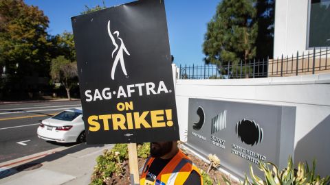 LOS ANGELES, CALIFORNIA - OCTOBER 11: A worker holding a picket sign stands in front of the Sony Pictures Studio during a SAG-AFTRA picket line on October 11, 2023 in Culver City, California. The WGA (Writers Guild of America) has reached a deal with Hollywood studios after 146 days on strike, ending their strike at midnight on September 27. SAG-AFTRA has not reached a deal with the studios and has been on strike since July 14. (Photo by Apu Gomes/Getty Images)