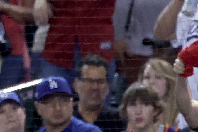 PHOENIX, ARIZONA - OCTOBER 11: Members of the Los Angeles Dodgers look on from the dugout in the ninth inning against the Arizona Diamondbacks during Game Three of the Division Series at Chase Field on October 11, 2023 in Phoenix, Arizona. (Photo by Elsa/Getty Images)