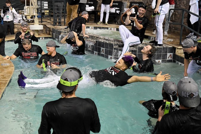 PHOENIX, ARIZONA - OCTOBER 11: Lourdes Gurriel Jr. #12 of the Arizona Diamondbacks dives into the pool after beating the Los Angeles Dodgers 4-2 in Game Three of the Division Series at Chase Field on October 11, 2023 in Phoenix, Arizona. (Photo by Norm Hall/Getty Images)