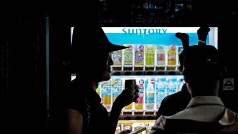 Revellers wearing costumes drink cans at the Shinjuku Ni-chome district, a famous LGBTQ neighbourhood in Tokyo, ahead of Halloween on October 28, 2023. (Photo by Philip FONG / AFP) (Photo by PHILIP FONG/AFP via Getty Images)