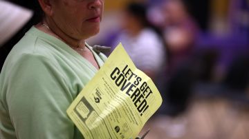 BAY POINT, CA - MARCH 28: An attendee holds a flyer as she waits to register for helathcare insurance during a healthcare enrollment fair at Ambrose Community Center on March 28, 2014 in Bay Point, California. With less than one week to go before the deadline to sign up for healthcare, SEIU-United Healthcare Workers West (SEIU-UHW) held a free healthcare enrollment fair to help people sign up for free and low-cost health coverage through Medi-Cal or Covered California. (Photo by Justin Sullivan/Getty Images)