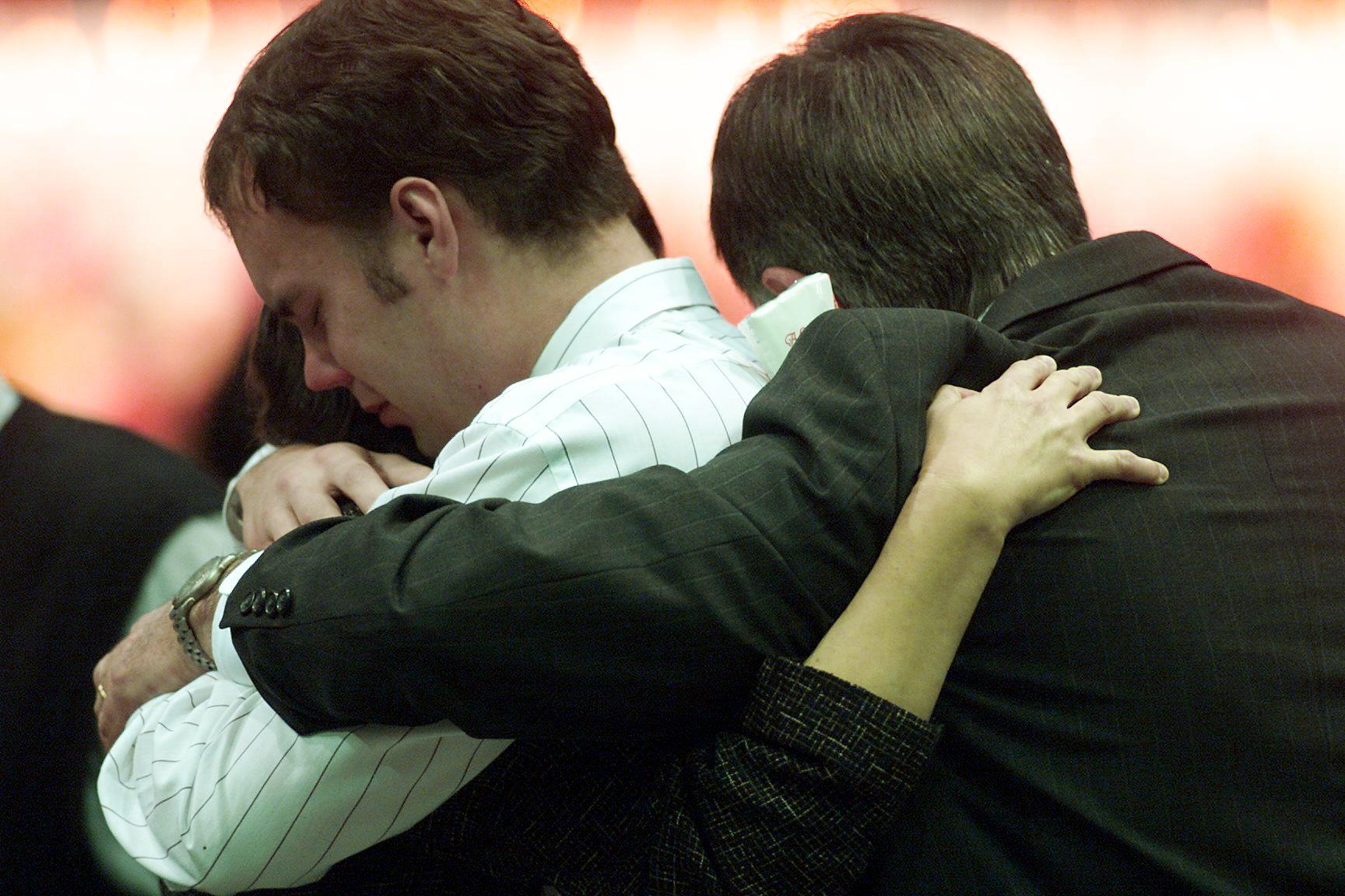 MALIBU, CA - FEBRUARY 5: The bereaved of victims from the Alaska Airlines flight 261 crash embrace one another during a memorial service at Pepperdine University 05 February, 2000 in Malibu, California, attended by hundred of relatives and friends of the 88 passengers and crew that died. Flight 261 crashed into the Pacific Ocean off the coast of California 31 January 2000 after experiencing a problem with its stabilizer. (ELECTRONIC IMAGE) (Photo credit should read BRYAN CHAN/AFP via Getty Images)