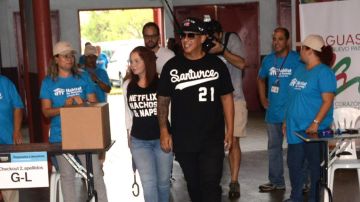 Daddy Yankee y Mireddys González realizando una labor humanitaria en Cagüas, Puerto Rico.