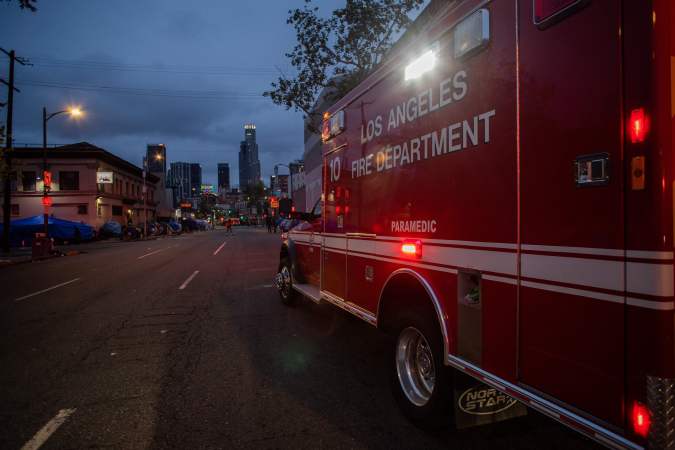 An ambulance of the LAFD Station No9 rides along Skid Row on April 12, 2020 in downtown Los Angeles, California. - One of the busiest fire station in the country , LA Fire Station 9 is on the front lines of California's homeless crisis e Coronavirus pandemic. (Photo by Apu GOMES / AFP) (Photo by APU GOMES/AFP via Getty Images)
