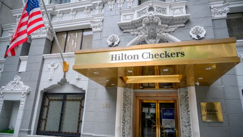 A sign is displayed in the doorway of the Hilton Checkers hotel, where operations are temporarily suspended amid the novel coronavirus pandemic, in downtown Los Angeles, California, on April 30, 2020. - A recent surge in the number of novel coronavirus cases and deaths linked to COVID-19 has brought California to two milestones, as the state is poised to surpass 50,000 infections and 2,000 deaths. (Photo by Robyn Beck / AFP) (Photo by ROBYN BECK/AFP via Getty Images)