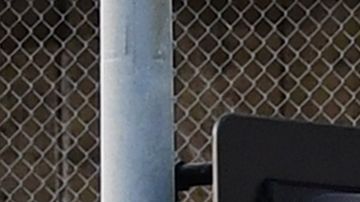 A man jogs past a row of telephone booths in front of the LA County Men's Central Jail on May 11, 2020 in Los Angeles, California. - Due to the coronavirus pandemic, more than 5,000 inmates have been released from county jails in an effort to slow the spread of the coronavirus but cases in the jail sysyem spiked 60% in the span of a week, according to numbers reported today by Sheriff Alex Villanueva. (Photo by Frederic J. BROWN / AFP) (Photo by FREDERIC J. BROWN/AFP via Getty Images)