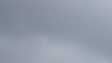 A person holds up a fist in front of a row of sheriff's deputies as relatives of Andres Guardado, who was shot and killed by a sheriff's deputy in Gardena, and activists rally to call on the city to rescind its policing contract, near the Compton Sheriff's Station in Compton, California, on June 28, 2020. (Photo by DAVID MCNEW / AFP) (Photo by DAVID MCNEW/AFP via Getty Images)