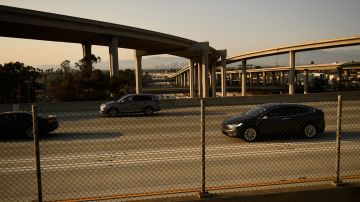 Vehicles drive on the 105 Freeway past the Los Angeles skyline at the Judge Harry Pregerson Interchange during rush hour traffic in Los Angeles, California on July 16, 2021. - The Metro C Line will eventually merge with the Crenshaw/LAX Transit Project as infrastructure modernization and transit construction projects continue at the airport ahead of the 2028 Los Angeles Olympics to reduce carbon emissions, traffic, and their impact towards climate change. (Photo by Patrick T. FALLON / AFP) (Photo by PATRICK T. FALLON/AFP via Getty Images)