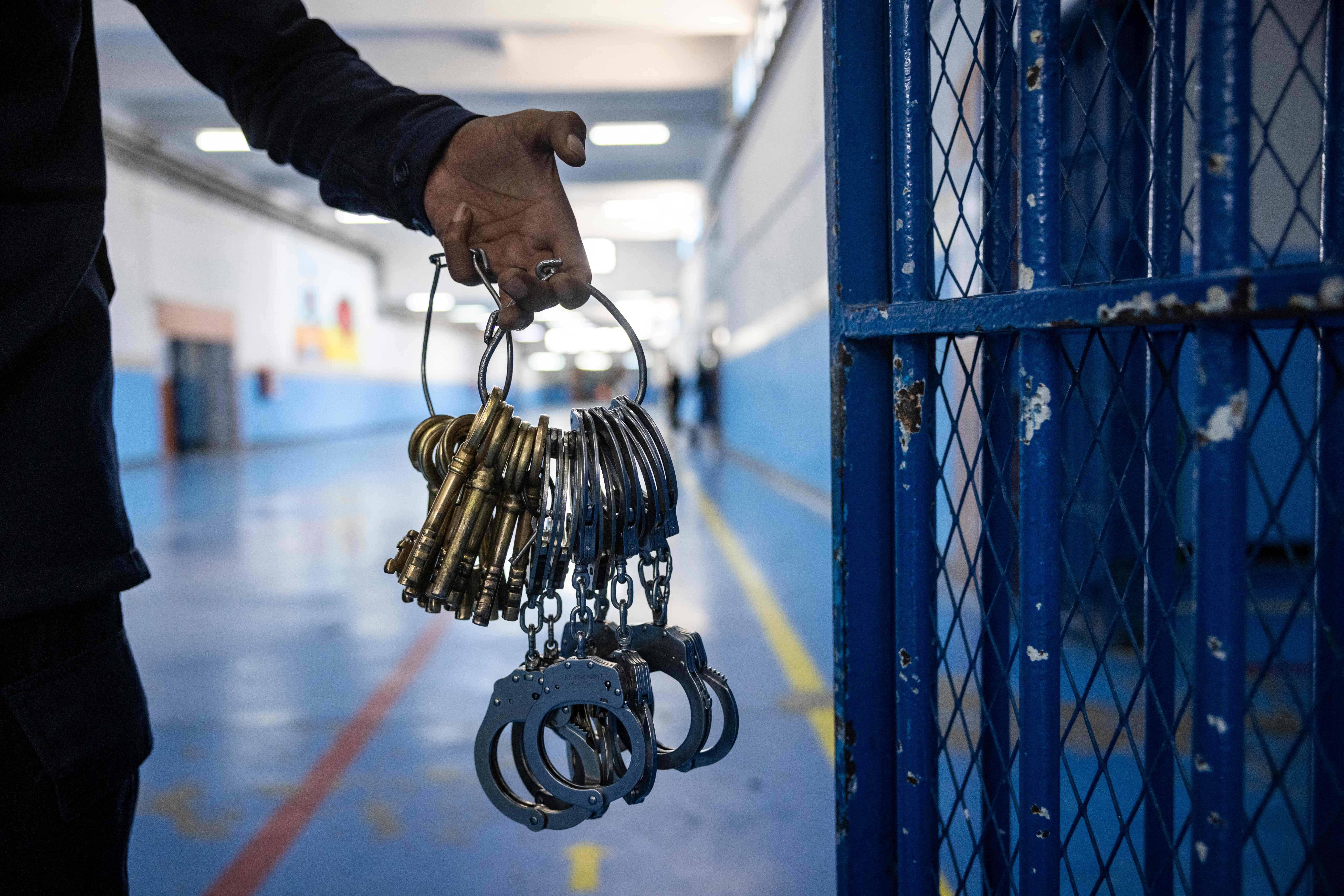 A guard carries keys and handcuffs at the prison of Kenitra, in the coastal city of the same name, near the Moroccan capital Rabat, on August 31, 2021. - After passing through the North African kingdom's Moussalaha ("Reconciliation") programme, some prisoners are hoping for a reprieve. The programme, launched in 2015 and led by Morocco's DGAPR prison service with several partner organisations, aims to help terror detainees who are willing to question their beliefs. (Photo by FADEL SENNA / AFP) (Photo by FADEL SENNA/AFP via Getty Images)