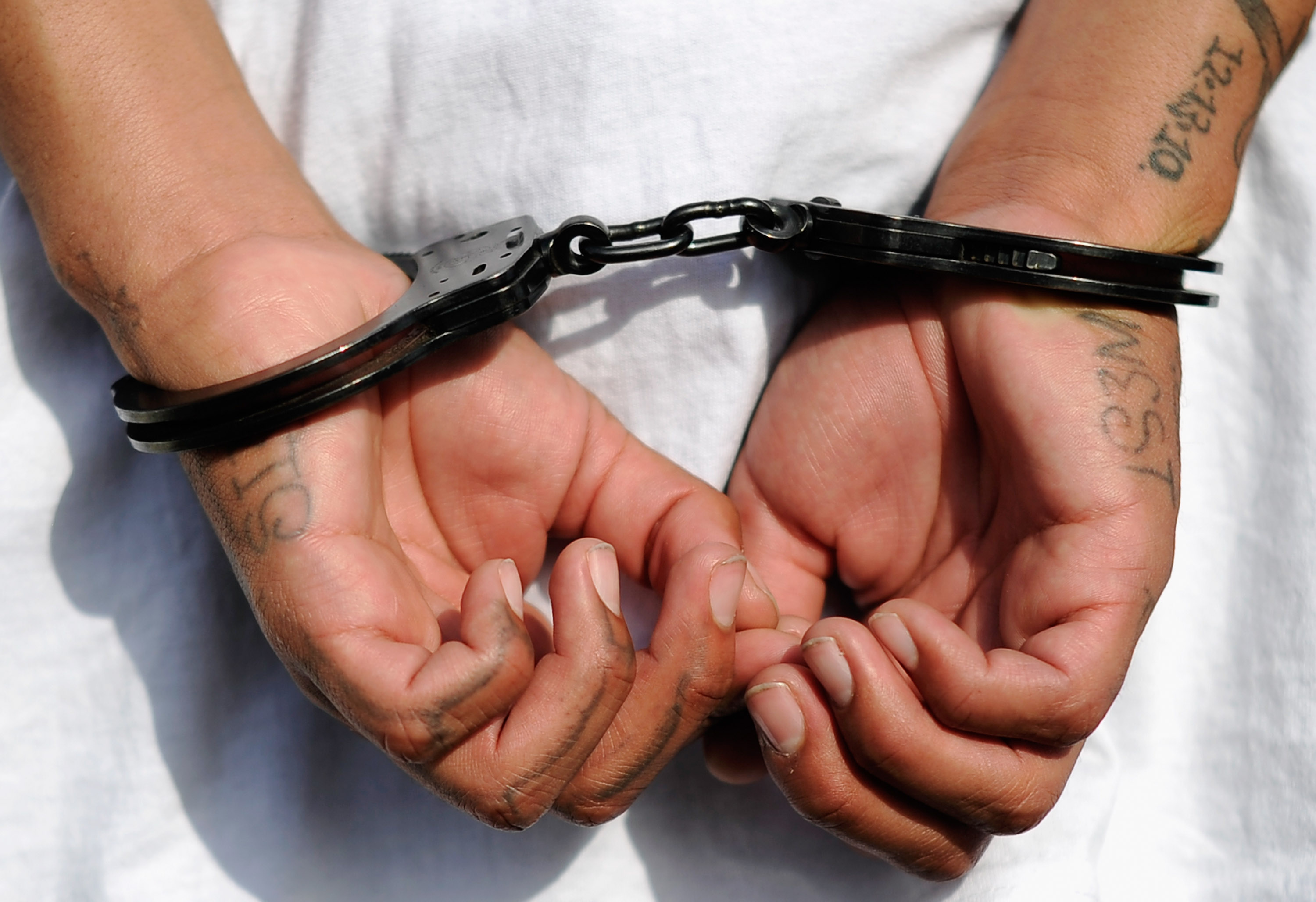 LOS ANGELES, CA - APRIL 29: Handcuffs are seen on the hands of a twenty-year old "Street Villains" gang member who was arrested by Los Angeles Police Department officers from the 77th Street division on April 29, 2012 in Los Angeles, California. The 77th Street division patrol the same neighborhood that truck driver Reginald Denny was nearly beaten to death by a group of black assailants at the intersection of Florence and Normandie Avenues. It’s been 20 years since the verdict was handed down in the Rodney King case that sparked infamous Los Angeles riots. (Photo by Kevork Djansezian/Getty Images)