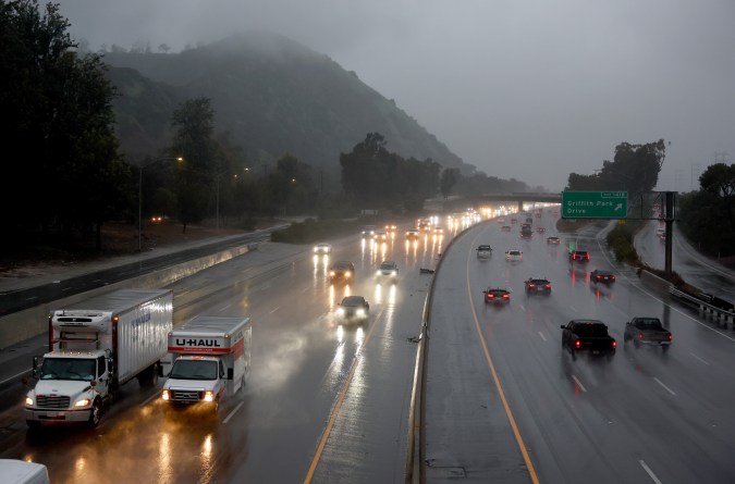 LOS ANGELES, CALIFORNIA - FEBRUARY 24: Vehicles drive through winter storm rains on Interstate 5 on February 24, 2023 in Los Angeles, California. A major storm, carrying a rare blizzard warning for parts of Southern California, has begun to deliver heavy snowfall to the mountains with some snowfall expected to reach lower elevations in Los Angeles County. Los Angeles is also seeing widespread heavy rains from the storm. (Photo by Mario Tama/Getty Images)