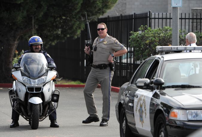SAN DIEGO, CA - FEBRUARY 7: California Highway Patrol officers stand guard as police officers search for suspect, former LAPD officer Christopher Jordan Dorner, at a hotel in the Point Loma area February 7, 2013 in San Diego, California. A manhunt is underway for Dorner, who is suspected of shooting at police officers in the Los Angeles area. (Photo by Denis Poroy/Getty Images)