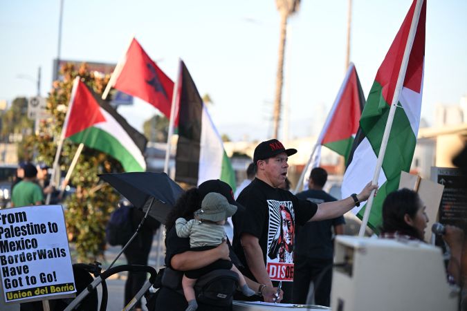 People demonstrate calling for peace and the end to the Israeli occupation of Palestine, in Los Angeles, California on October 12, 2023, after the Palestinian militant group Hamas launched an attack on Israel. Hamas gunmen killed 1,200 people in Israel and took about 150 hostages in their surprise onslaught launched from Gaza on October 7, 2023. Israel has retaliated by raining air and artillery strikes on Hamas targets in Gaza for six days, claiming more than 1,400 lives. Rally organizers noted in their press release that the rally was not an anti-Semitic event and it is not against Jewish people and not in support of terrorism, adding, "We are in full support of the Palestinian struggle for liberation and self- determination." (Photo by Robyn Beck / AFP) (Photo by ROBYN BECK/AFP via Getty Images)