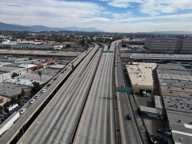 An aerial view shows an empty Interstate-10 freeway, also called the Santa Monica Freeway, in Los Angeles, California, on November 13, 2023, after a large pallet fire burned the area on November 11, 2023. California Governor Gavin Newsom has declared a state of emergency as the busy freeway is closed indefinitely while infrastructure officials assess whether the structural integrity of the freeway has been compromised. (Photo by Robyn Beck / AFP) (Photo by ROBYN BECK/AFP via Getty Images)