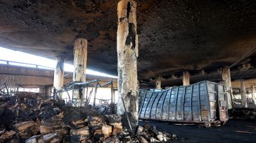LOS ANGELES, CALIFORNIA - NOVEMBER 13: Fire damage is viewed beneath the closed I-10 elevated freeway following a large pallet fire, which occurred Saturday at a storage yard, on November 13, 2023 in Los Angeles, California. Engineers have been assessing the extent of the damage and it remains unknown how long the freeway, which is a major commuter artery through the downtown area, will remain closed and complicate traffic for the city. California Governor Gavin Newsom said the fire was caused by arson and that over 300,000 vehicles drive through the freeway corridor each day with drivers being urged to use public transit. (Photo by Mario Tama/Getty Images)