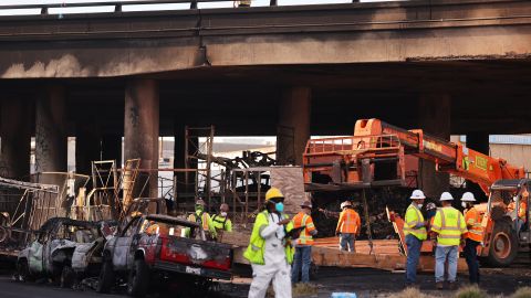 LOS ANGELES, CALIFORNIA - NOVEMBER 13: Crews work beneath the closed I-10 elevated freeway following a large pallet fire, which occurred Saturday at a storage yard beneath the freeway, on November 13, 2023 in Los Angeles, California. Engineers have been assessing the extent of the damage and it remains unknown how long the freeway, which is a major commuter artery through the downtown area, will remain closed and complicate traffic for the city. California Governor Gavin Newsom said the fire was caused by arson and that over 300,000 vehicles drive through the freeway corridor each day with drivers being urged to use public transit. (Photo by Mario Tama/Getty Images)