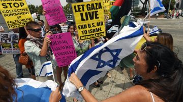 Protestors and counter-protestors shout slogans at each other during a demonstration against Israel's military operations in the Gaza Strip, August 2, 2014 in front of the Federal Building in Los Angeles, California. The Israeli army on Saturday gave a first indication it was ending operations in parts of Gaza, while continuing to bombard other areas ahead of fresh truce talks in Cairo. The devastating 26-day Gaza conflict has so far claimed more than 1,660 Palestinian lives and forced up to a quarter of the territory's population into exile. On the Israeli side, 63 soldiers and three civilians have died. AFP PHOTO / Robyn Beck (Photo credit should read ROBYN BECK/AFP via Getty Images)