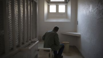 A journalist takes notes on September 10, 2014 in a cell at the Sante prison in Paris. The only jail in Paris, inaugurated in 1867, closed for renovations on July 21 and is to reopen in 2019 with its prisoners transferred to other facilities. The Sante is known for its VIP section, where various well-known figures have done time. AFP PHOTO/JOEL SAGET (Photo credit should read JOEL SAGET/AFP via Getty Images)
