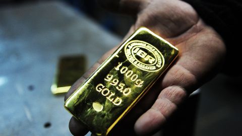 TO GO WITH AFP STORY BY PHILIPPE ALFROY A gold worker holds a 1 KG gold bullion at Istanbul Gold Refinery (IGR) on January 13, 2015 in Istanbul. Since 2007, Turkish banks have opened gold accounts in their branches to collect gold bullions, coins, jewels as well as scrap gold that Turkish people are keeping "under the pillow" and to reintroduce it in the financial system so it can benefit the whole economy. It is estimated that Turkish households have accumulated at least 3,500 tons of gold "under the pillow".AFP PHOTO/OZAN KOSE (Photo by Ozan KOSE / AFP) (Photo by OZAN KOSE/AFP via Getty Images)