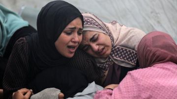 Mujeres en el hospital de Al Aqsa velan a sus seres queridos tras un bombardeo el domingo.
