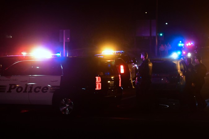 TOPSHOT - Police officers are seen at the intersection of US 101 freeway and the Moorpark Rad exit as police vehicles close off the area responding to a shooting at a bar in Thousand Oaks, California on November 8, 2018. - Twelve people, including a police sergeant, were shot dead in a shooting at a nighttclub close to Los Angeles, police said Thursday. All the victims were killed inside the bar in the suburb of Thousand Oaks late on Wednesday, including the officer who had been called to the scene, Sheriff Geoff Dean told reporters. The gunman was also dead at the scene, Dean added. The bar was hosting a college country music night. (Photo by Frederic J. BROWN / AFP) (Photo credit should read FREDERIC J. BROWN/AFP via Getty Images)