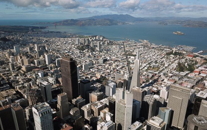 Downtown San Francisco, California is seen from above on February 6, 2019. - San Francisco, once home to flower power, hippies and dope, has changed dramatically: these days, it is all about Facebook, Twitter and Google, the multi-billion dollar tech giants who have turned it into one of the world's most expensive cities to live in. Average monthly rent for a two-room apartment in the city by the bay now runs to $3,700, the highest in the United States. And a household of four with annual earnings of less than $117,400 is officially officially considered "low income." "We see now a kind of homelessness that did not occur before, people who work, that is new, said Cary McClelland, author of the 2018 book "Silicon City" which examines how the city has changed. (Photo by Josh Edelson / AFP) (Photo credit should read JOSH EDELSON/AFP via Getty Images)