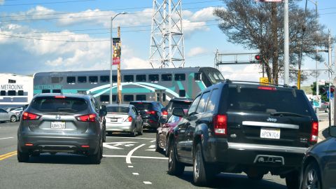 Vehicular traffic comes to a stop as a Metrolink commuter passenger train passes in Los Angeles on April 9, 2019, where gas prices across southern California, already the highest in the nation, continue to rise. (Photo by Frederic J. BROWN / AFP) (Photo credit should read FREDERIC J. BROWN/AFP via Getty Images)