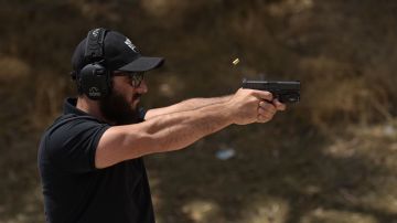 Rabbi Raziel Cohen, aka "Tactical Rabbi", shoots a Glock 9mm pistol during a demonstration at the Angeles Shooting Ranges in Pacoima, California on May 20, 2019. - Armed guards, safety assessments and now even a "Tactical Rabbi" to train volunteers on the use of weapons -- such is the reality today at synagogues in the United States facing mounting anti-Semitic attacks. It is at a shooting range in the hills overlooking Los Angeles that a team of AFP reporters met recently with Raziel Cohen, dubbed the "Tactical Rabbi," who was sporting a 9mm pistol on his hip and carrying a semi-automatic rifle over his shoulder. (Photo by Agustin PAULLIER / AFP) (Photo credit should read AGUSTIN PAULLIER/AFP via Getty Images)