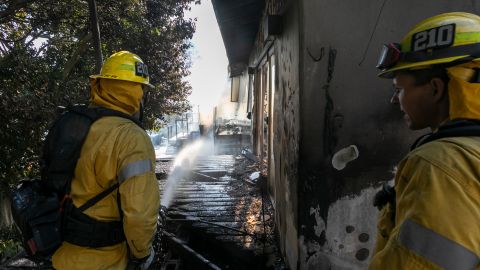 LOS ANGELES, CA - OCTOBER 28: Firefighters hose down a house burning in the Getty Fire on October 28, 2019 in Los Angeles, California. Reported at 1:30 a.m., the fire quickly burned 600 acres and several homes and forced evacuations in an area near the Getty Center. (Photo by David McNew/Getty Images)