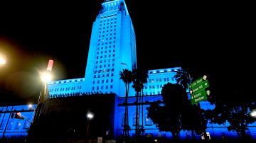 LOS ANGELES, - APRIL 16: A view of Los Angeles City Hall illuminated in blue on April 16, 2020 in Los Angeles, United States. Landmarks and buildings across the nation are displaying blue lights to show support for health care workers and first responders on the front lines of the COVID-19 pandemic. (Photo by Frazer Harrison/Getty Images)