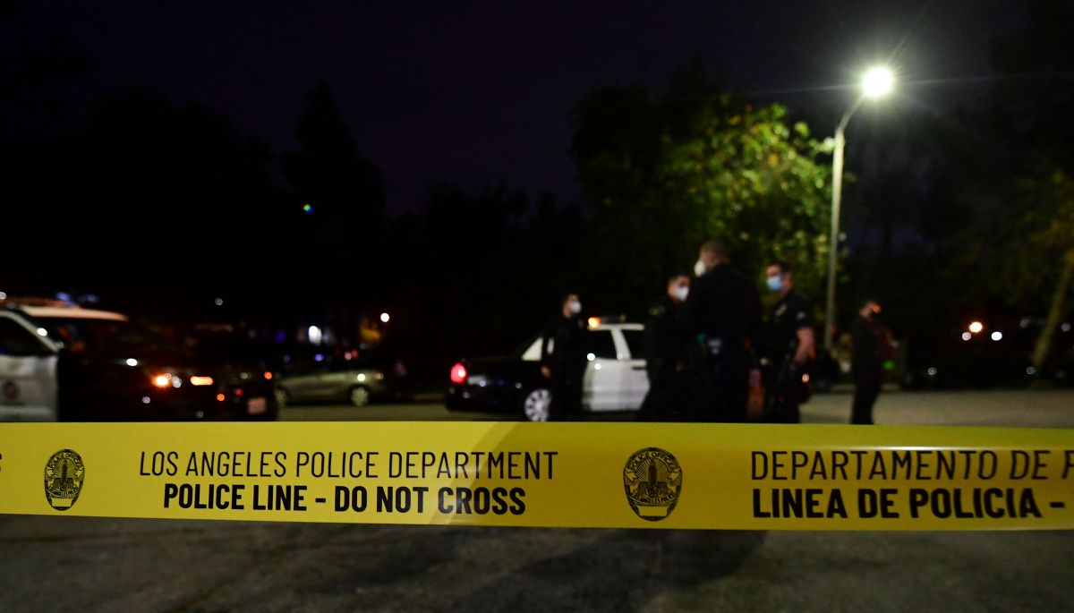Police tape closes off a street as officers arrive on scene at Echo Park Lake in Los Angeles, March 24, 2021, ahead of a planned and announced cleanup of the encampment as part of an estimated half-million-dollar City of Los Angeles cleanup and repair effort. (Photo by Frederic J. BROWN / AFP) (Photo by FREDERIC J. BROWN/AFP via Getty Images)